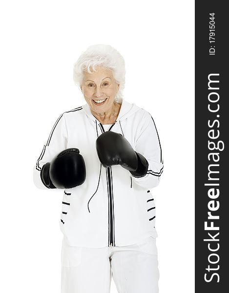 Elderly woman with boxing gloves in a white background