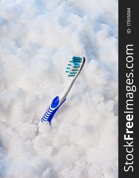 New blue toothbrush on a blue snow. New blue toothbrush on a blue snow