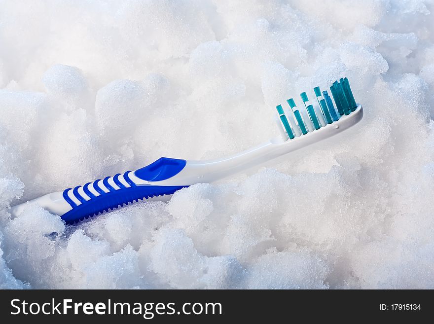 New blue toothbrush on a blue snow. New blue toothbrush on a blue snow