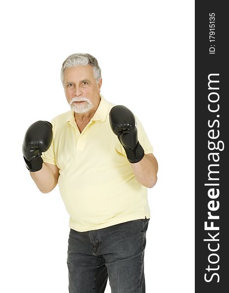 Elderly man with boxing gloves in a white background