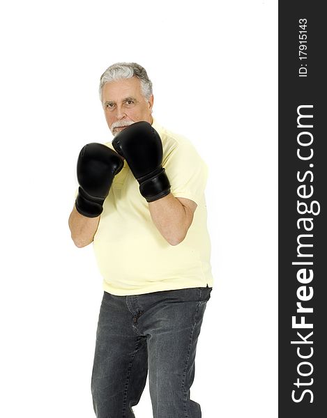 Elderly man with boxing gloves in a white background