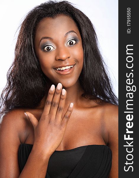 Headshot of beautiful young black girl, with big happy smile and surprised expression on her face. Headshot of beautiful young black girl, with big happy smile and surprised expression on her face.