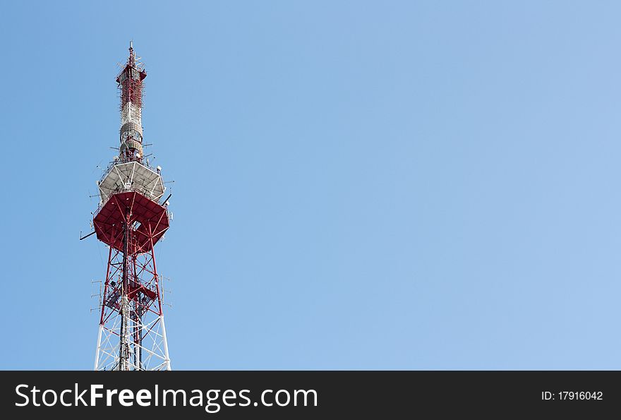 Tele communication tower over blue cloudless sky