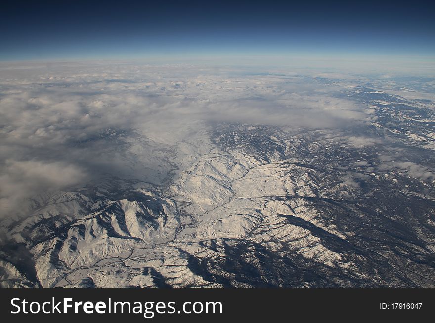 Aerial view of snow covered rockies