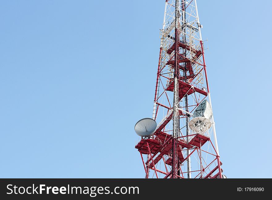 Telecommunication tower over blue cloudless sky