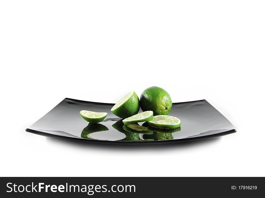 Three sliced limes and plate on white background. Three sliced limes and plate on white background