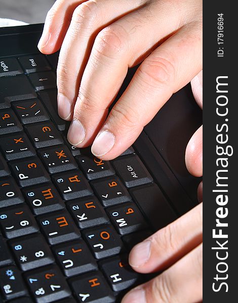 Hands typing at the laptop keyboard. Hands typing at the laptop keyboard