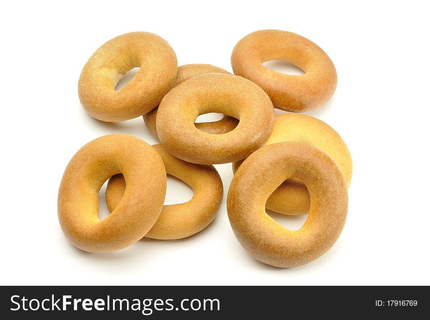 heap of small bagels on white background