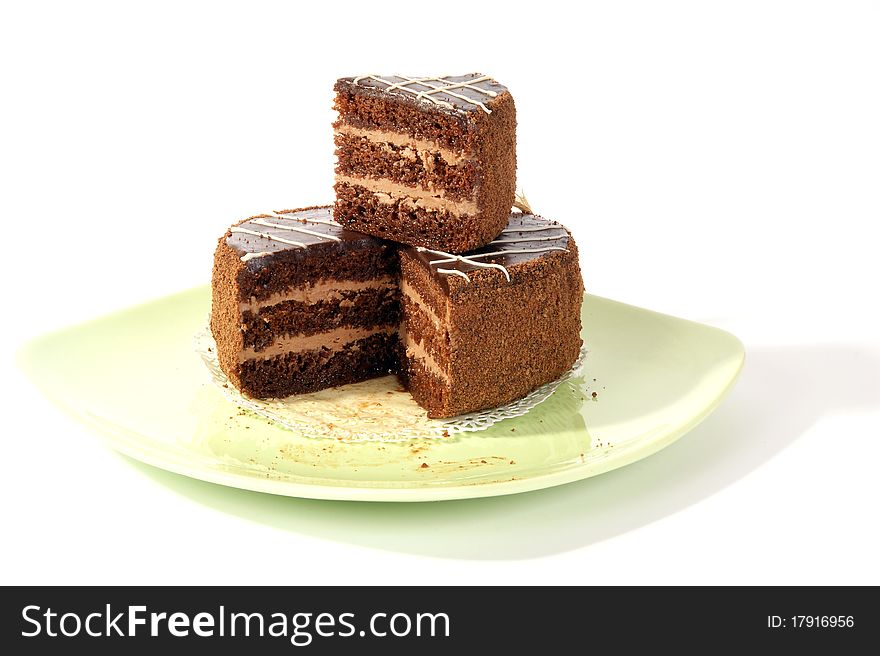 A large piece of cake on a saucer, on a white background