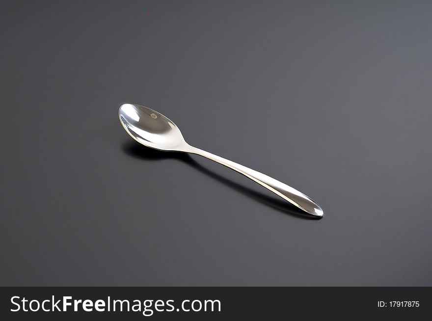 Silver spoon on a black table