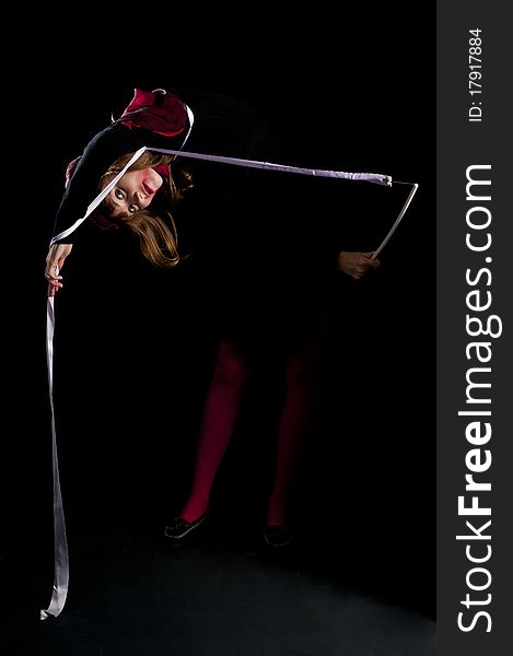 Beautiful girl with red stockings and ribbon on black background