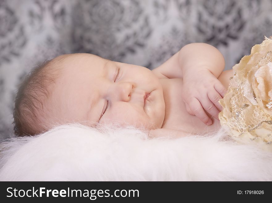 Baby sleeping and holding flower. Baby sleeping and holding flower