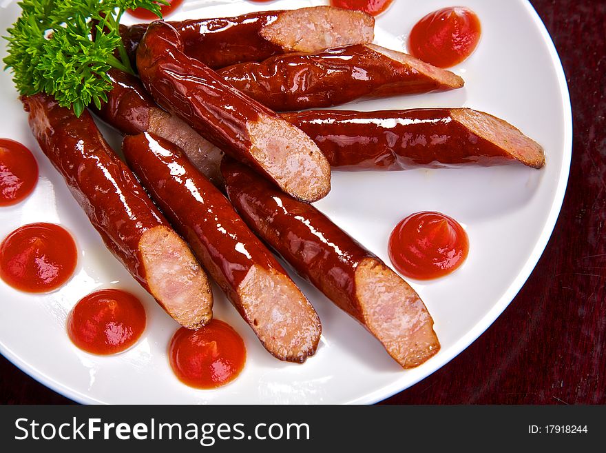 Appetizing Bavarian sausages with sauce and greens