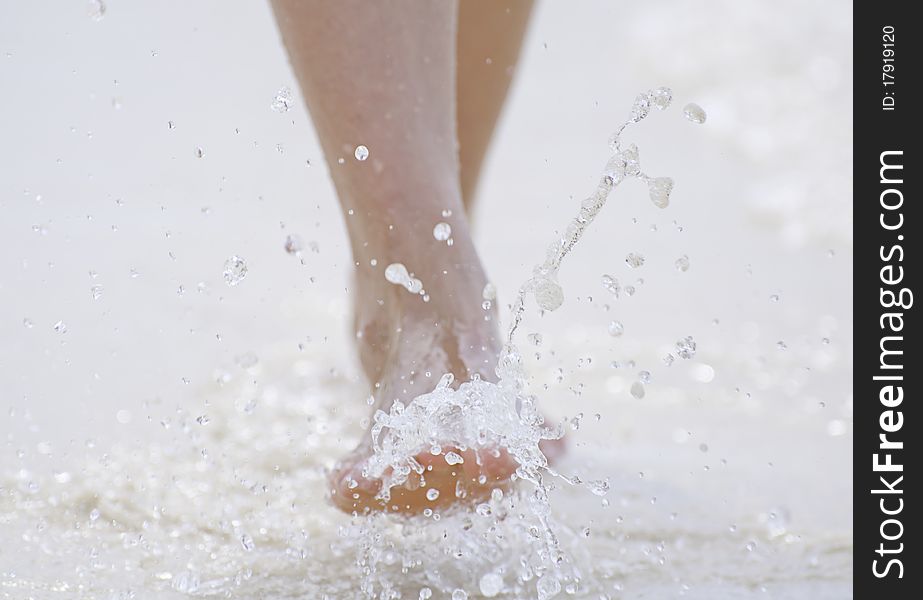 Foot splash while walking on the beach