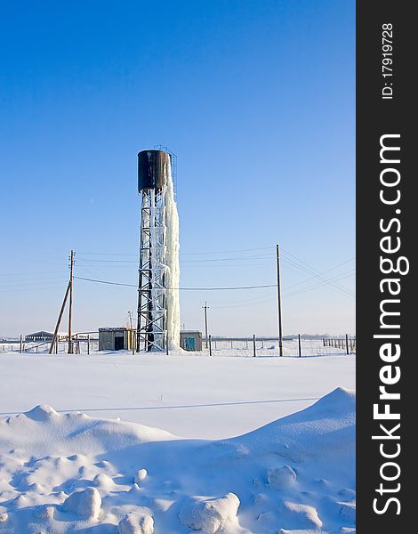 View of  frozen beneath  ice water tower in  winter in  field. View of  frozen beneath  ice water tower in  winter in  field.