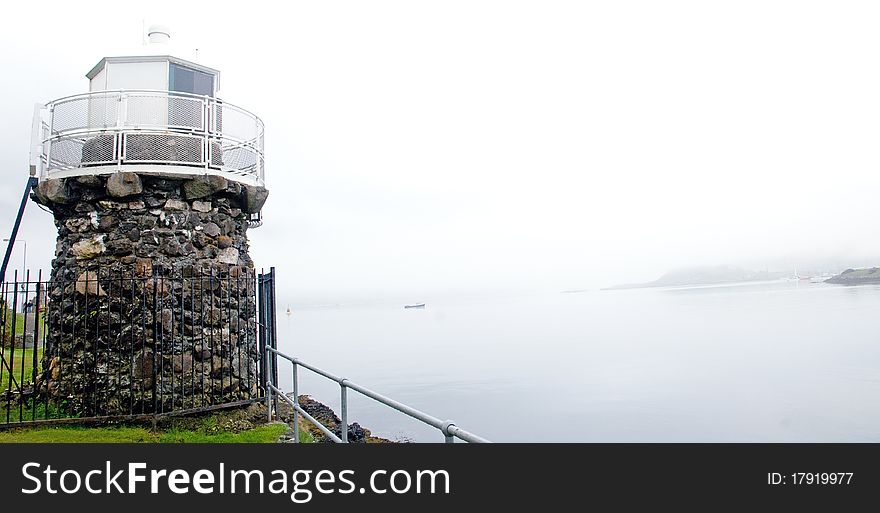 The misty lighthouse and landscape of dunollie near oban in scotland. The misty lighthouse and landscape of dunollie near oban in scotland