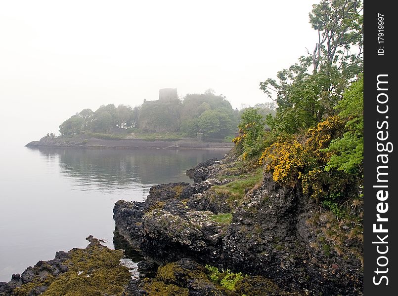 Rocks and misty scottish castle