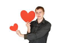 Man Holding Red Paper Hearts And Looking On It Royalty Free Stock Image