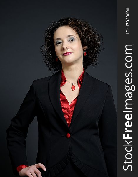 White elegant business woman posing with red accessories and black suit. White elegant business woman posing with red accessories and black suit