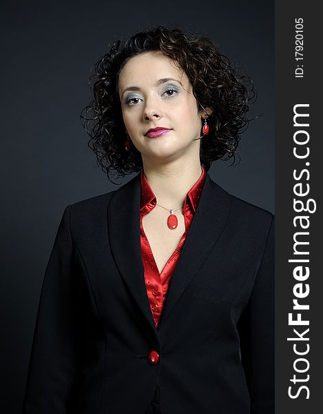 White elegant business woman posing with red accessories and black suit. White elegant business woman posing with red accessories and black suit