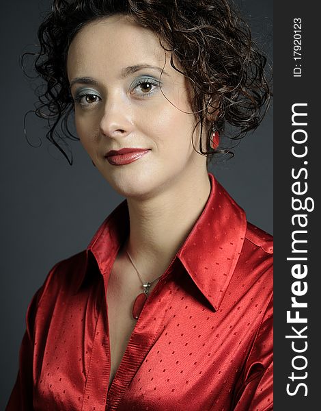 White elegant  business woman posing with red accessories in studio. White elegant  business woman posing with red accessories in studio