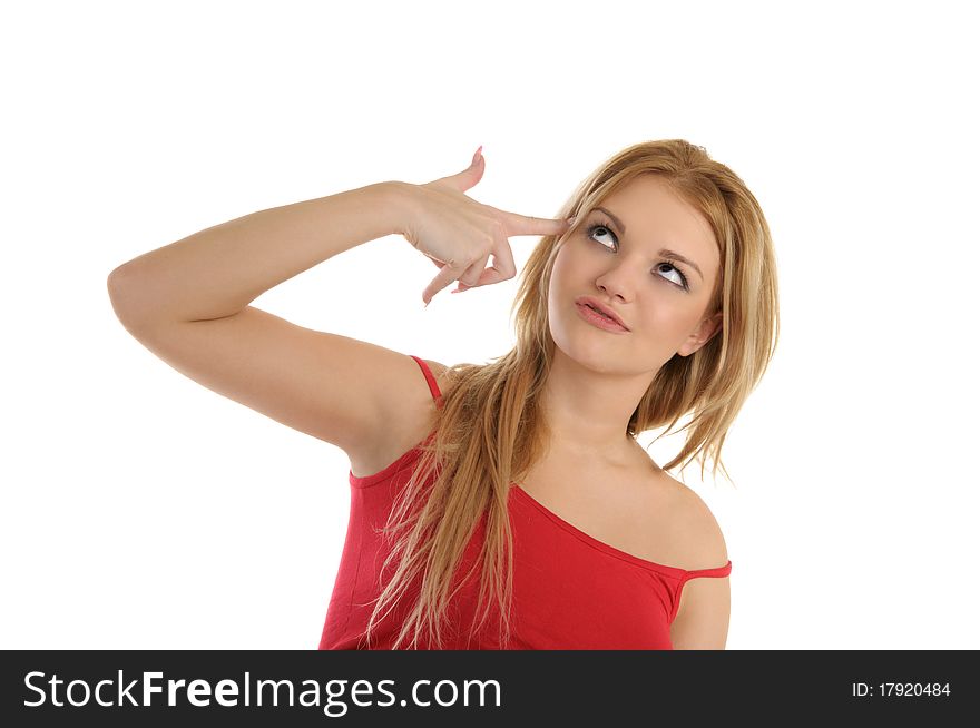 Young woman holds finger at temple isolated in white