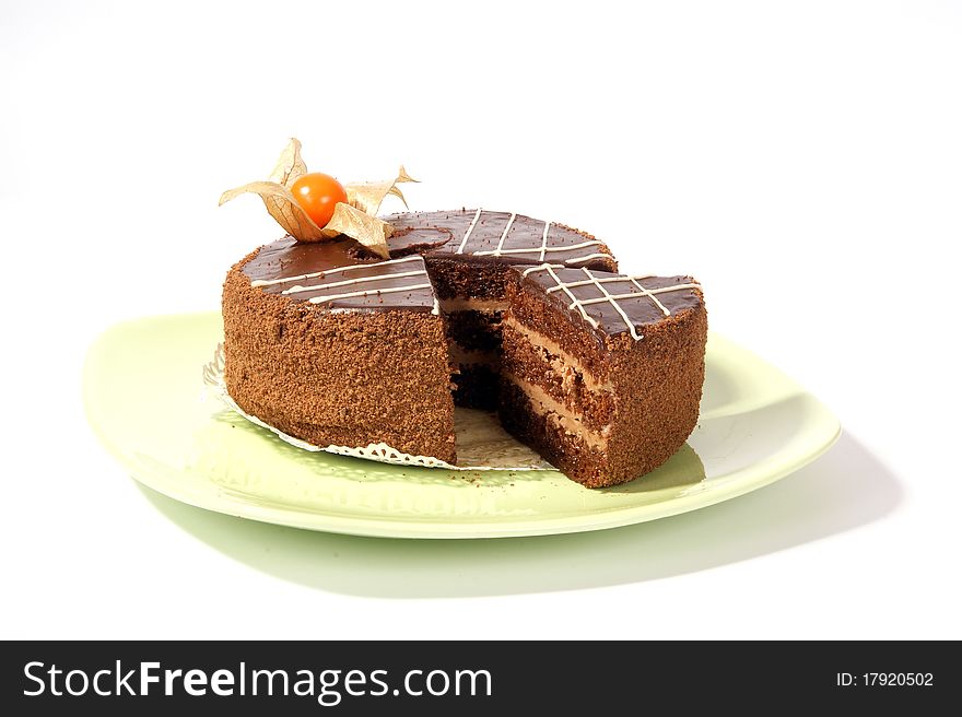 A large piece of cake on a saucer, on a white background