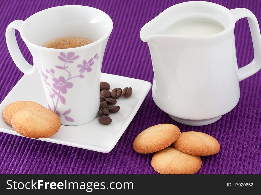 Cup of coffee with biscuits and milk