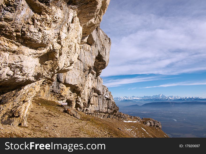 View on Mont-Blanc snow caps over Geneva valley and rock cliff in front