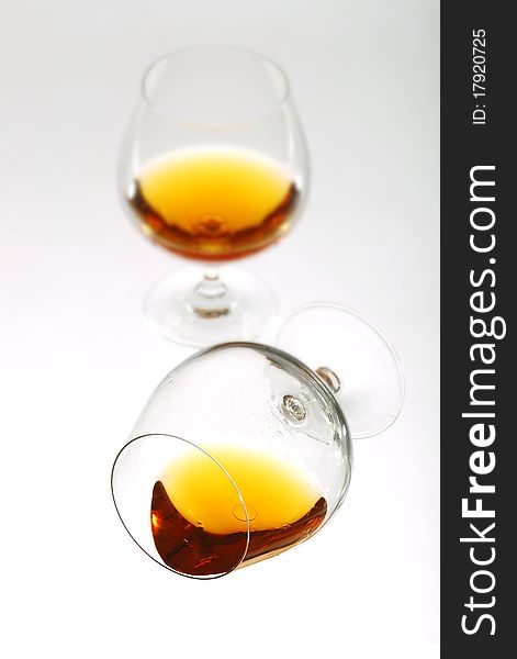 Glass of cognac over white background