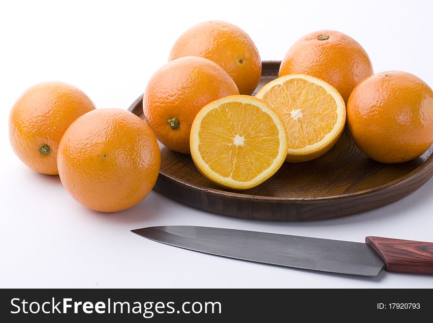 Orange in and out wooden plate on white