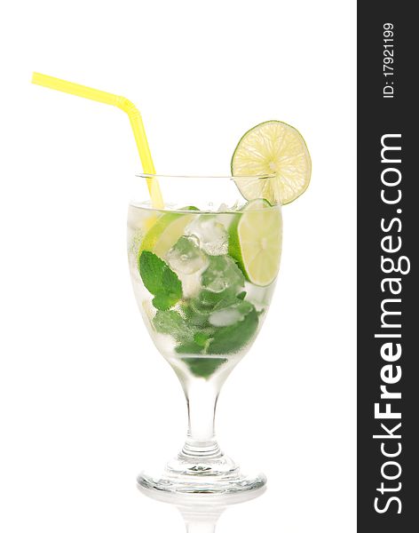 Classic Mojito cocktail drink with alcohol, rum, lime, spring of mint, sprite soda, syrup and yellow straw in cocktail glass isolated on a white background