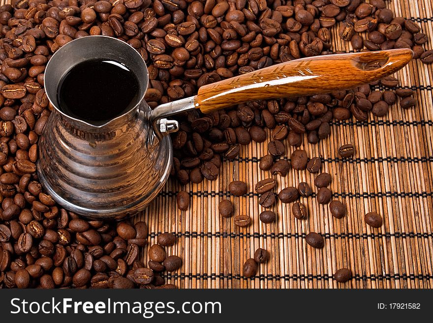 Roasted coffee beans and coffee pot