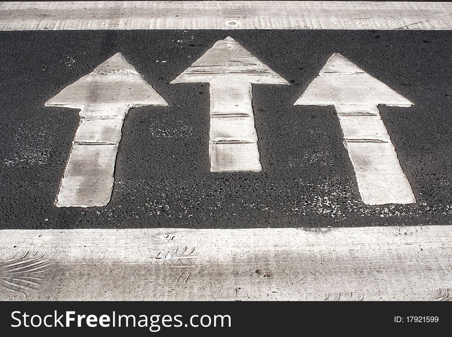 White arrows painted on road