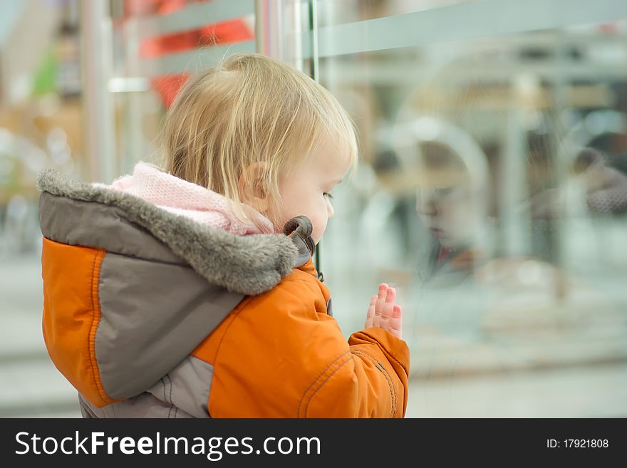 Adorable baby and fence in supermarket