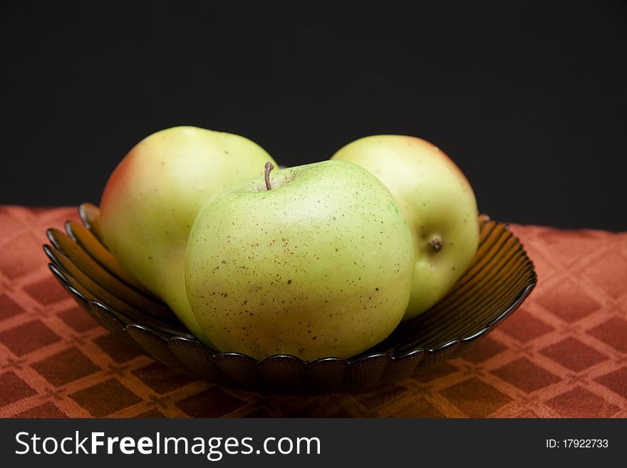 Apple and pears in the glass bowl