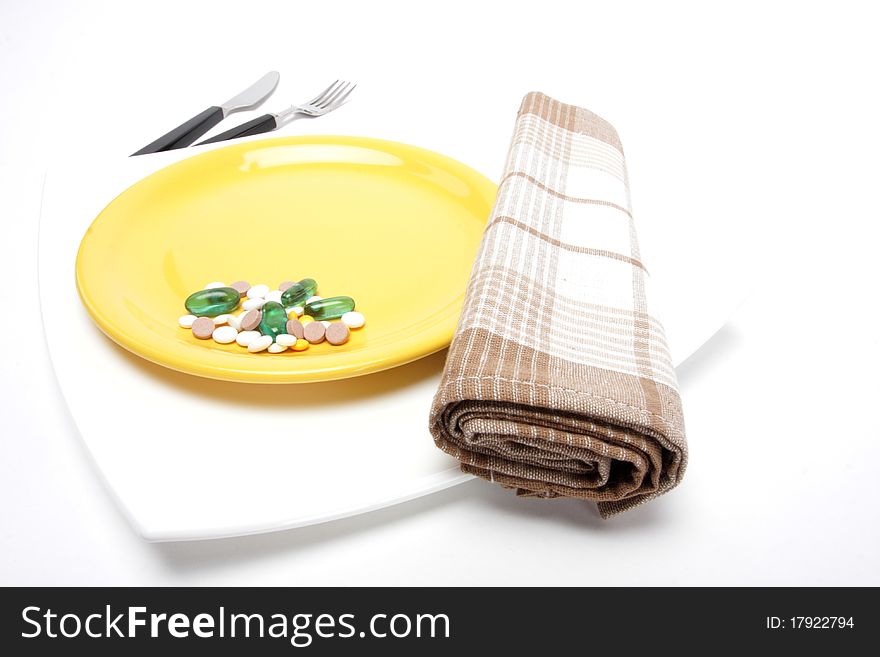 Place setting with plate and pills. Place setting with plate and pills