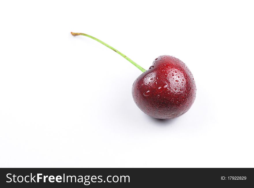 There is a cherry with drop of water. There is a cherry with drop of water