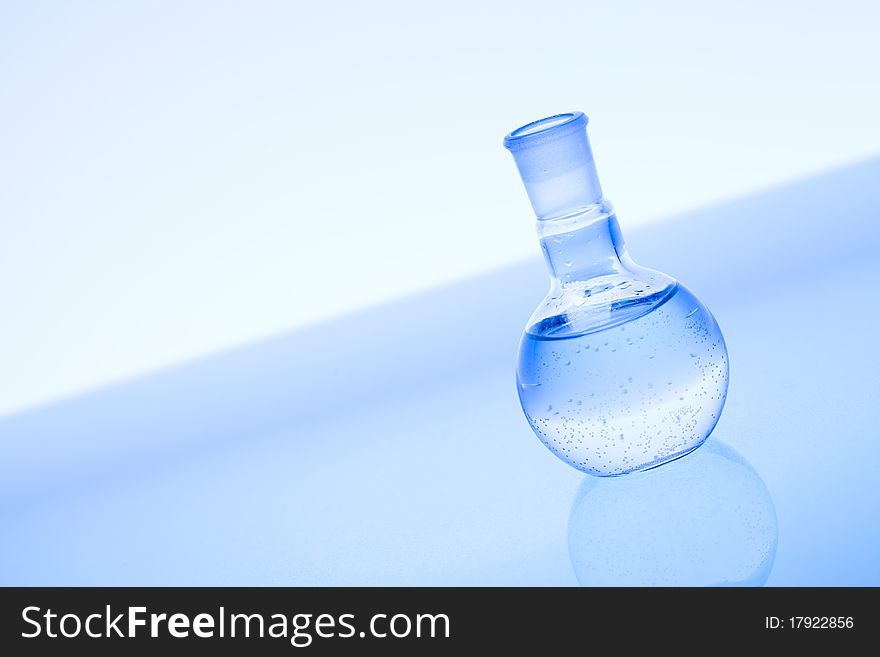 Laboratory glass and water. Blue scene.