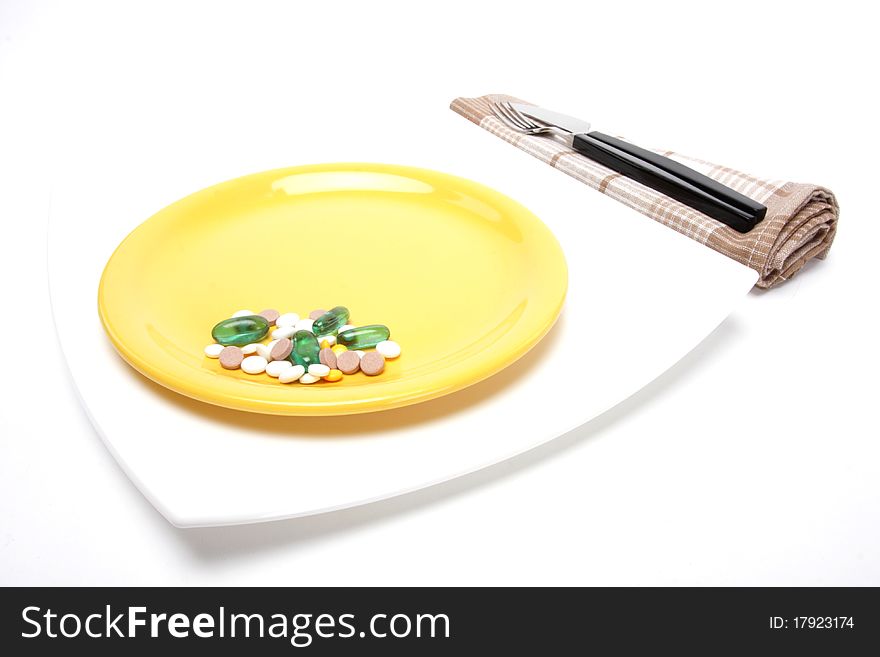 Place setting with plate and pills. Place setting with plate and pills