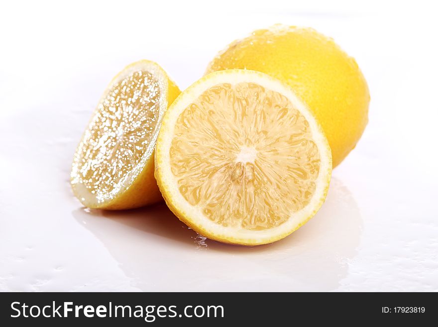 Fresh and wet lemon on white background. Fresh and wet lemon on white background