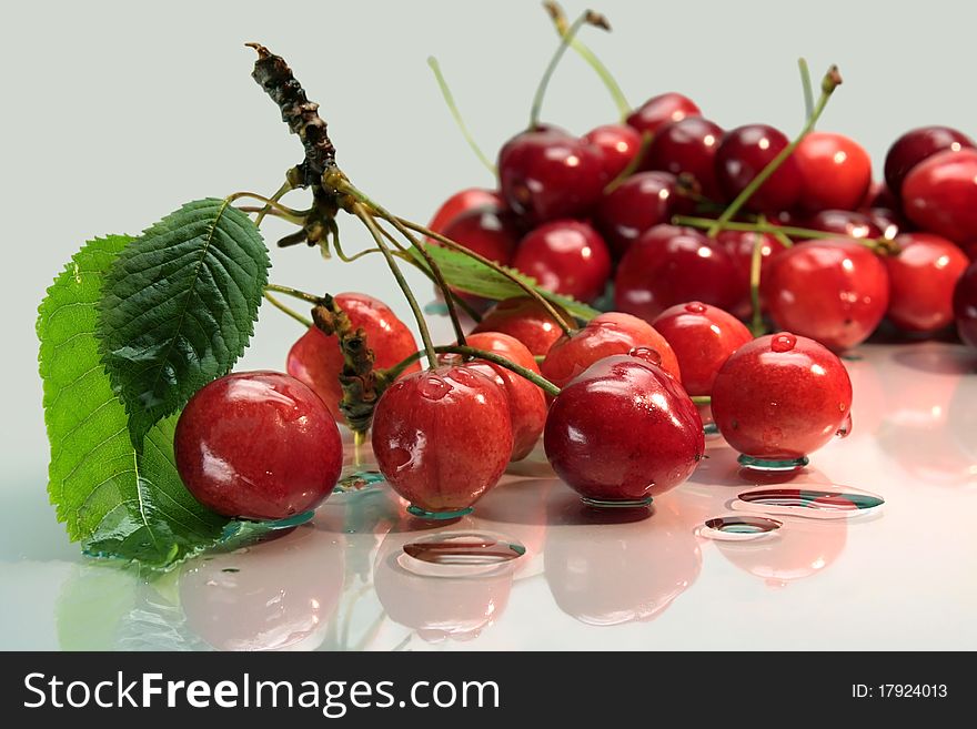 Cherries on glass plate with drops