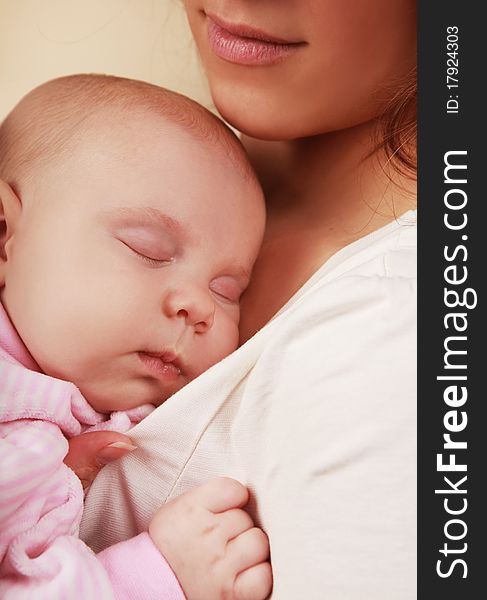 Beautiful little girl asleep on mother's chest. Beautiful little girl asleep on mother's chest