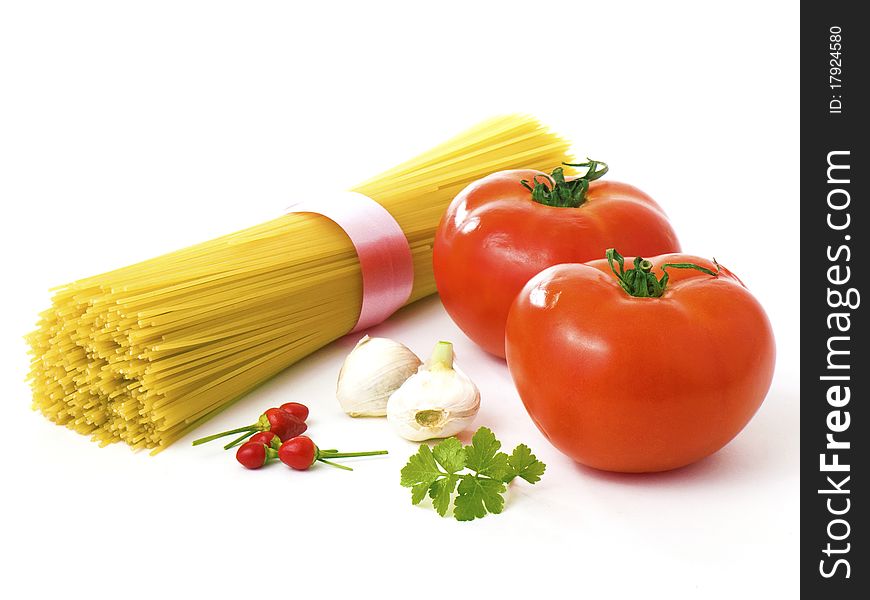 Tomatoes, garlic, peppers, basil and spaghettis isolated on white background