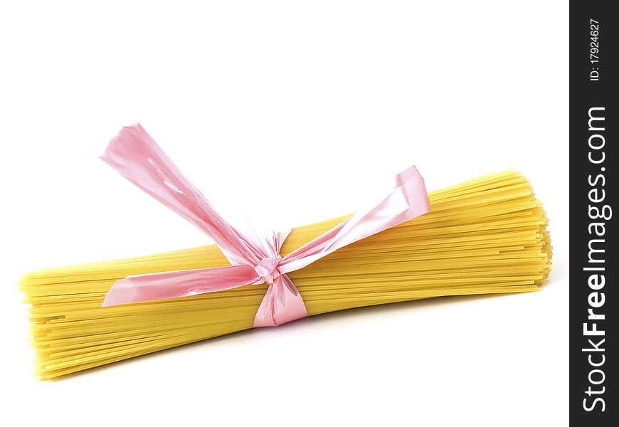 Spaghettis horizontally tied up with pink ribbon isolated on white background. Spaghettis horizontally tied up with pink ribbon isolated on white background