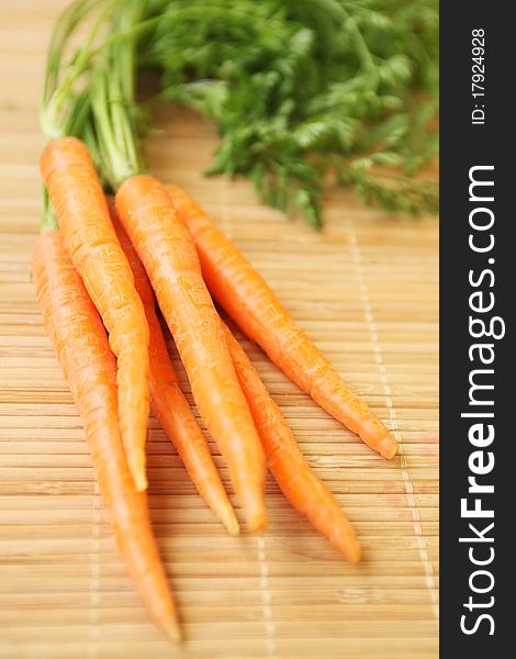Bunch of carrots on wooden pad. Bunch of carrots on wooden pad