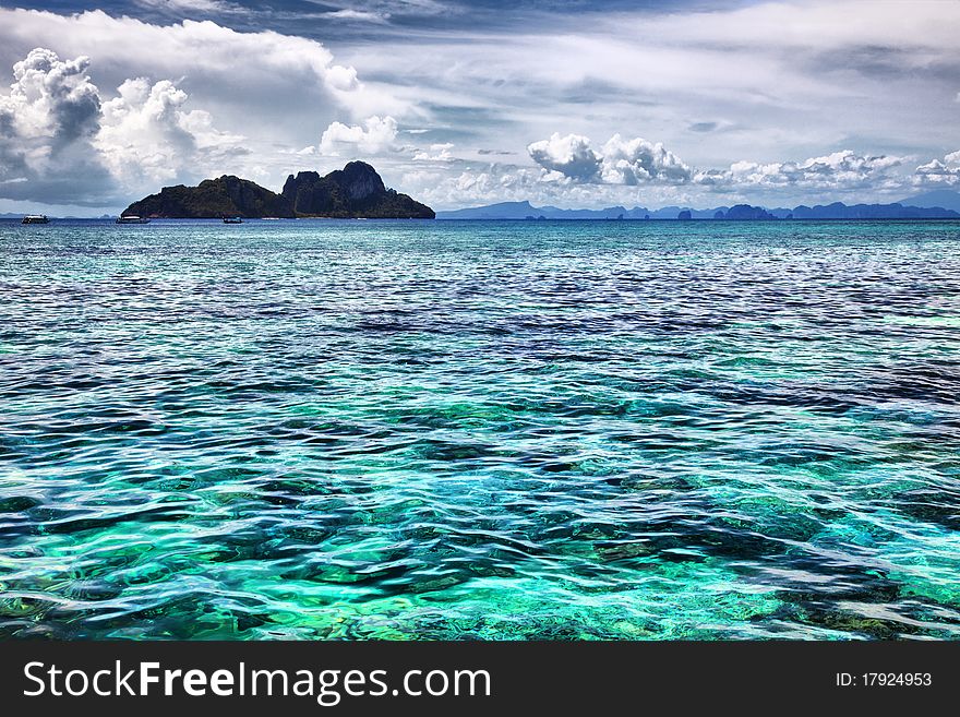 Seascape. Turquoise water, clouds and islands.