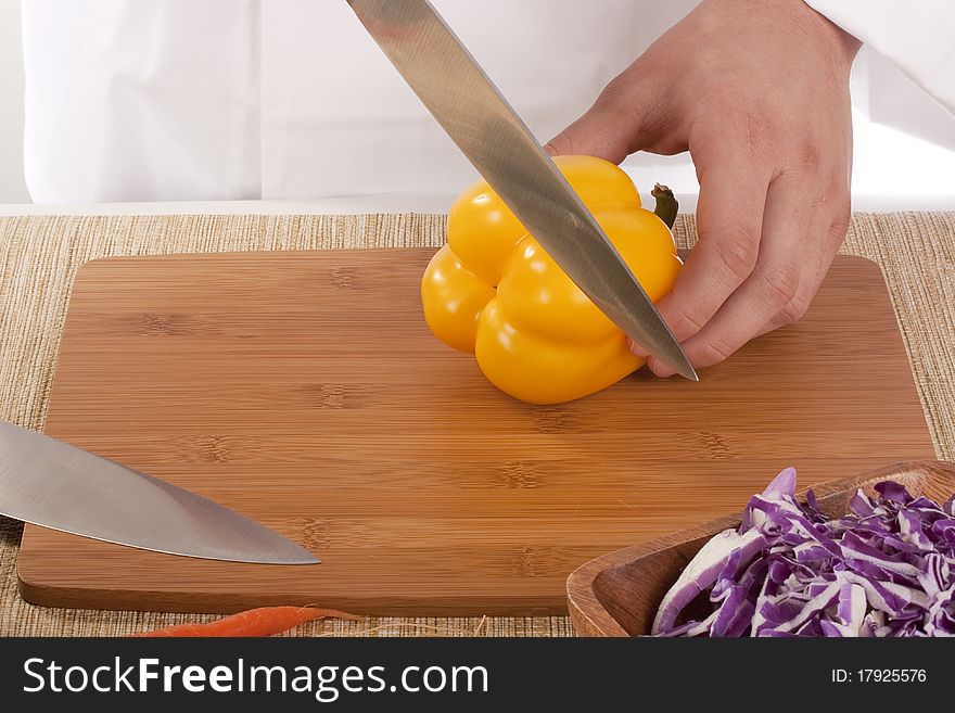 Chef Man cut vegetables on kitchen blackboard.