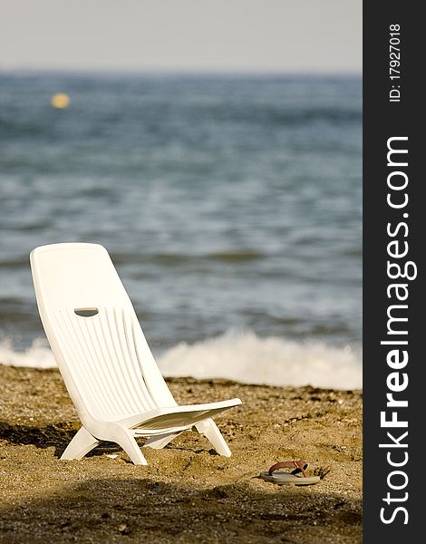 Beach sitting chair and flip flops. Beach sitting chair and flip flops