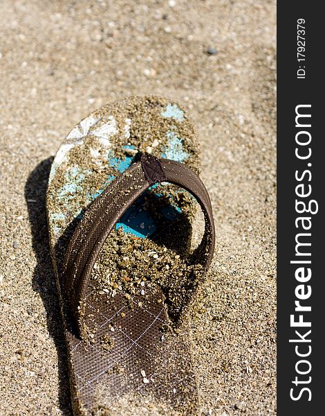 Flip flop on sandy beach in front of the sea. Flip flop on sandy beach in front of the sea